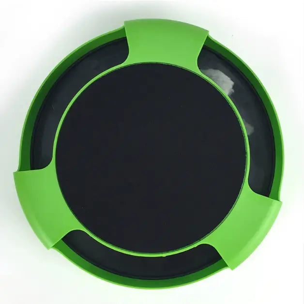 green plastic circular coaster with a black center and three evenly spaced cutouts for the cat catch interactive mouse hunting toy designed for indoor cats.