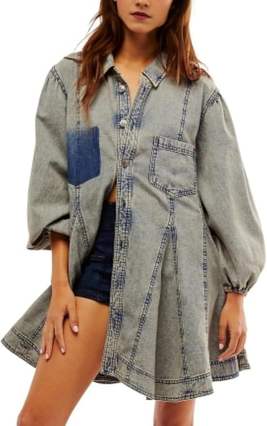 A light-wash denim shirt dress with a button-up front, contrasting dark blue patch pocket on the left side, rolled cuffs, and lantern sleeves.
