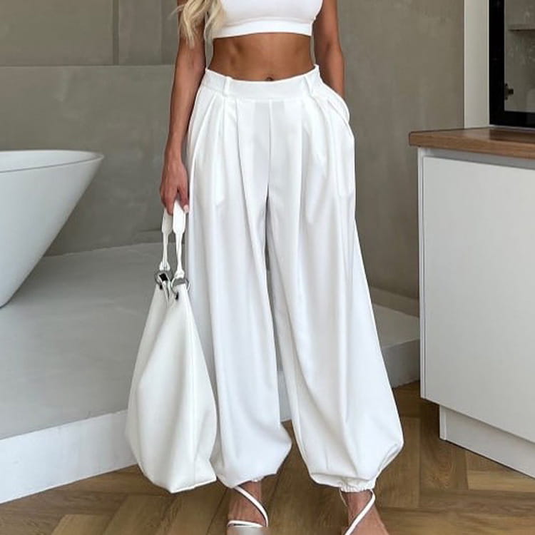White high waisted balloon jogger pants with a relaxed flowing silhouette and elastic cuffs.