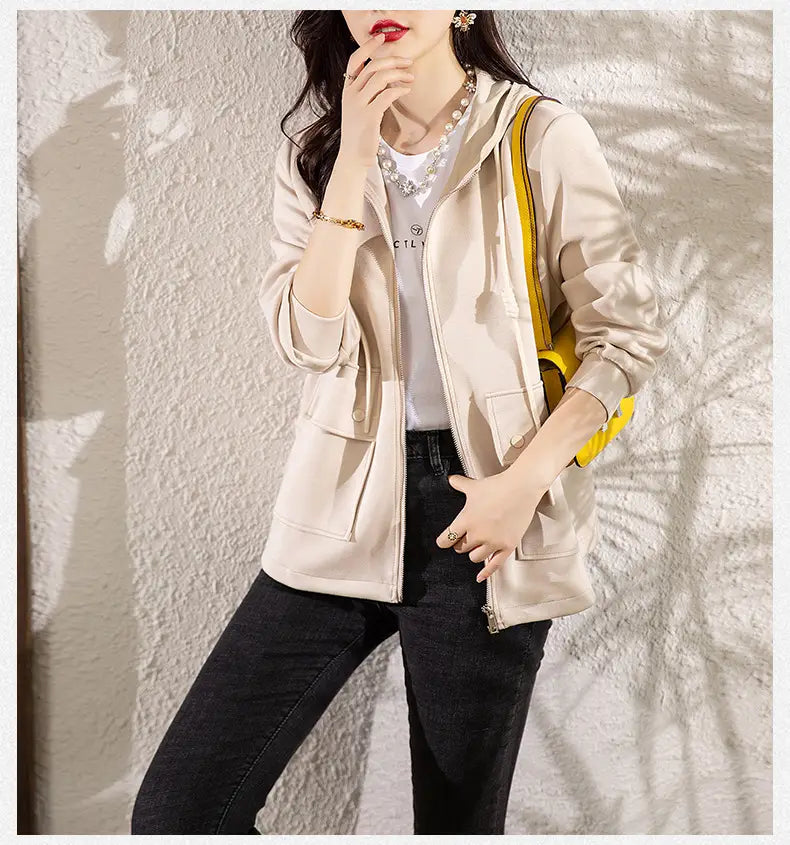 Beige Kapuzen-Cropped-Jacke aus Satinfutter mit gelben Akzenten am Schulterriemen und vorderem Reißverschluss.
