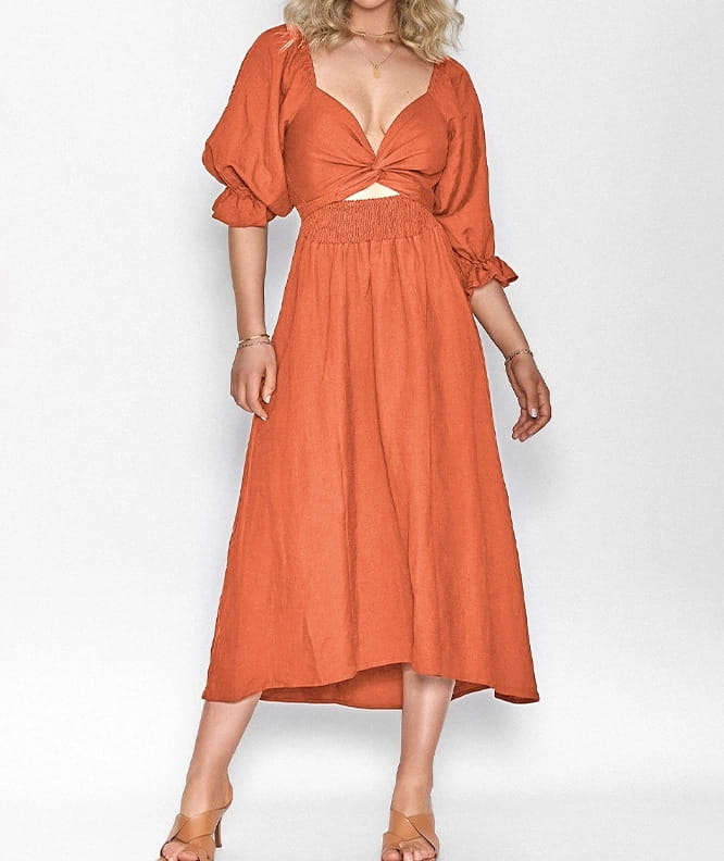 A flowing orange midi dress with puffed lantern sleeves and a tied waist featuring a v-neck design.
