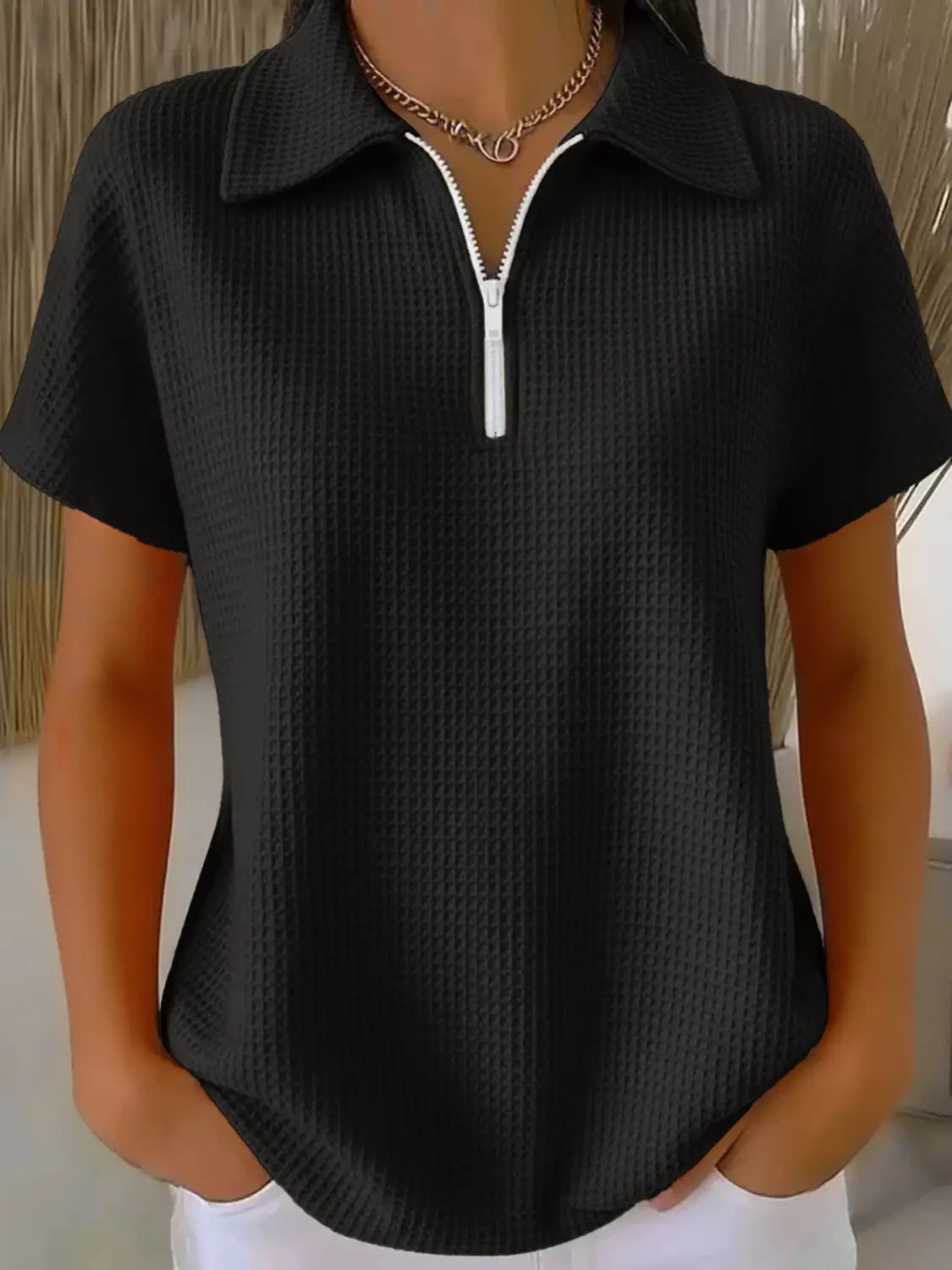 Black ribbed waffle knit short sleeve polo shirt with a white collar and zipper pull for a casual and stylish look.