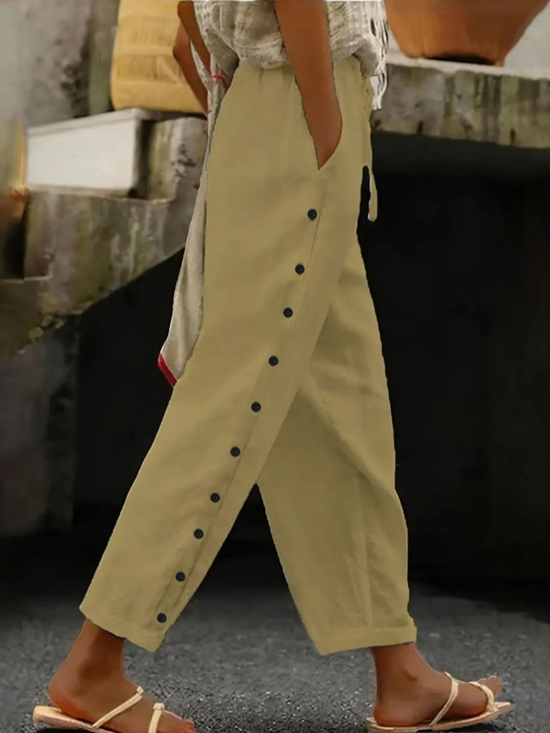 Beige cotton cropped patchwork button casual pants for women featuring black button detailing down the side seam.