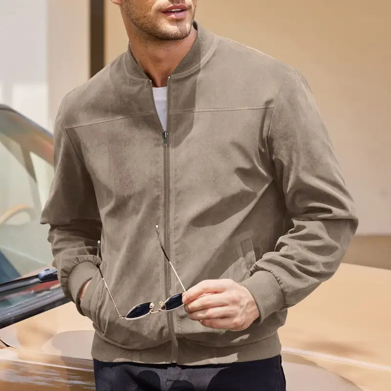 A taupe suede men suede casual retro jacket featuring a central zipper and ribbed cuffs.