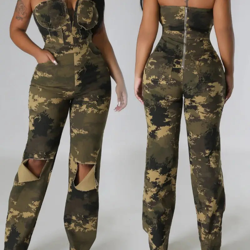 Camouflage flared denim jumpsuit featuring distressed knee rips and a front zipper in a green camouflage pattern.