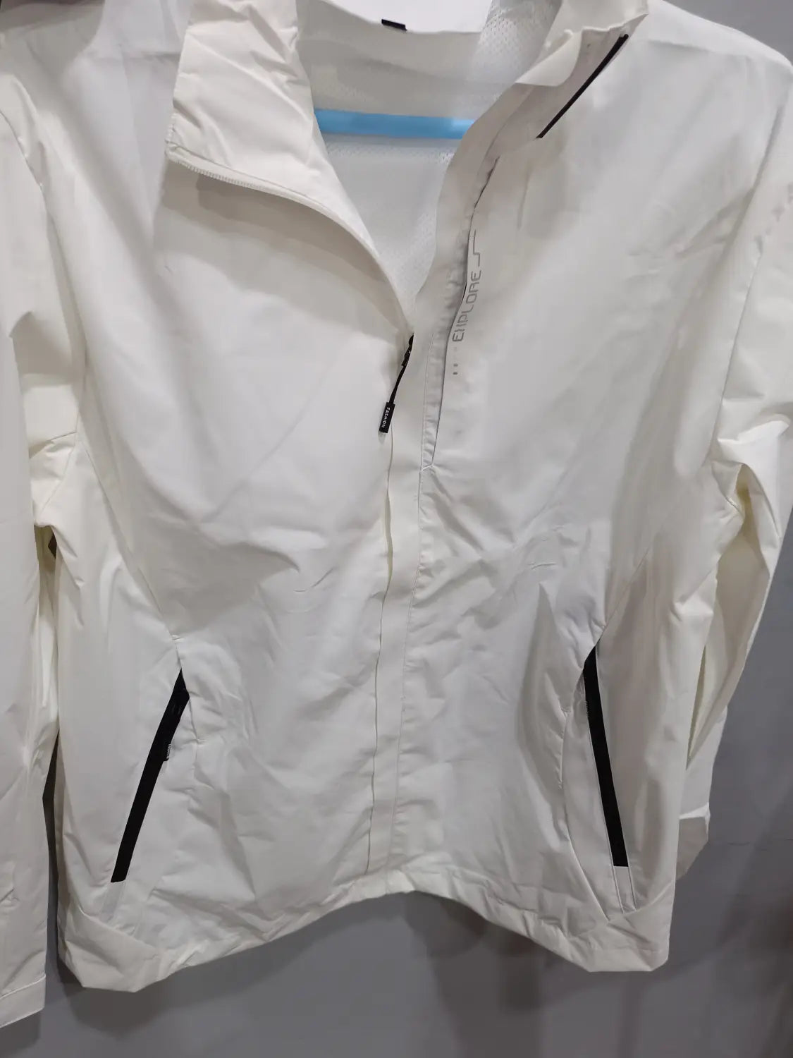 White waterproof hiking jacket for men with black zipper accents and a subtle brand logo on the chest designed as a hooded windbreaker.