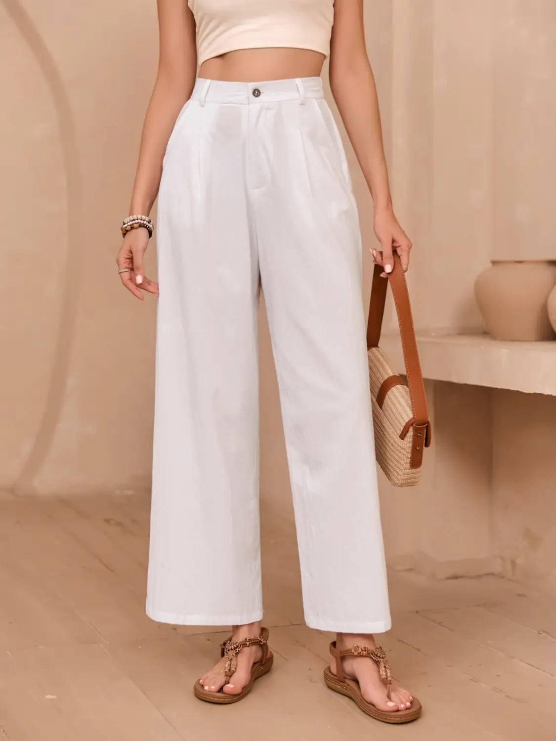 White linen wide leg high waisted pants with a clean tailored cut and subtle pleats