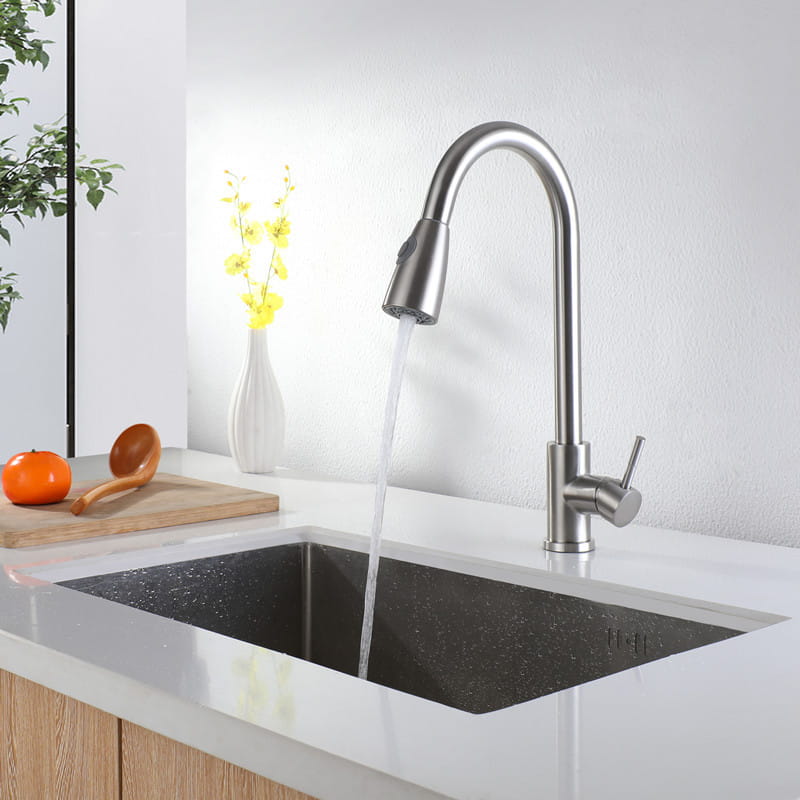 Golden smart touch pull out kitchen faucet in brushed stainless steel with a modern sleek curved spout and pull-down spray head.