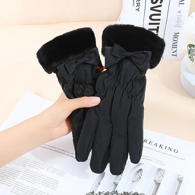 black women touch screen winter fleece gloves showing the back side with plush fur trim and decorative bows on each hand