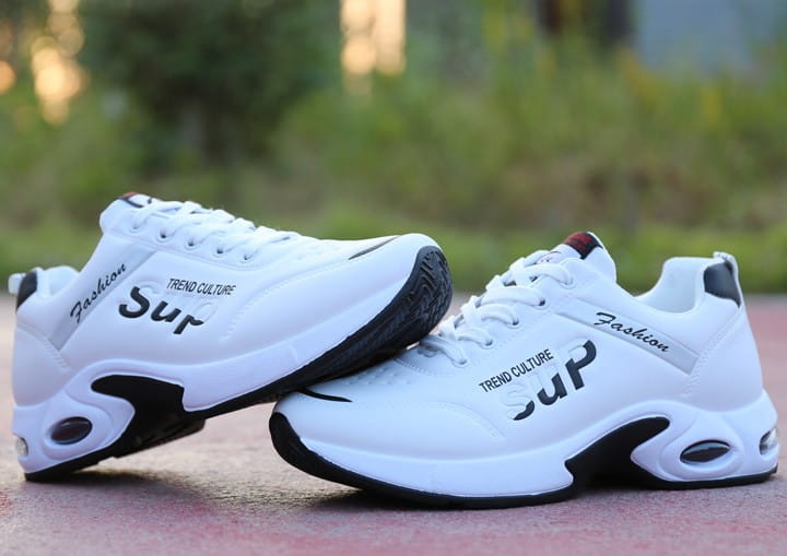 White leather men’s casual sportswear running shoes with black accents and trend culture branding on the side.