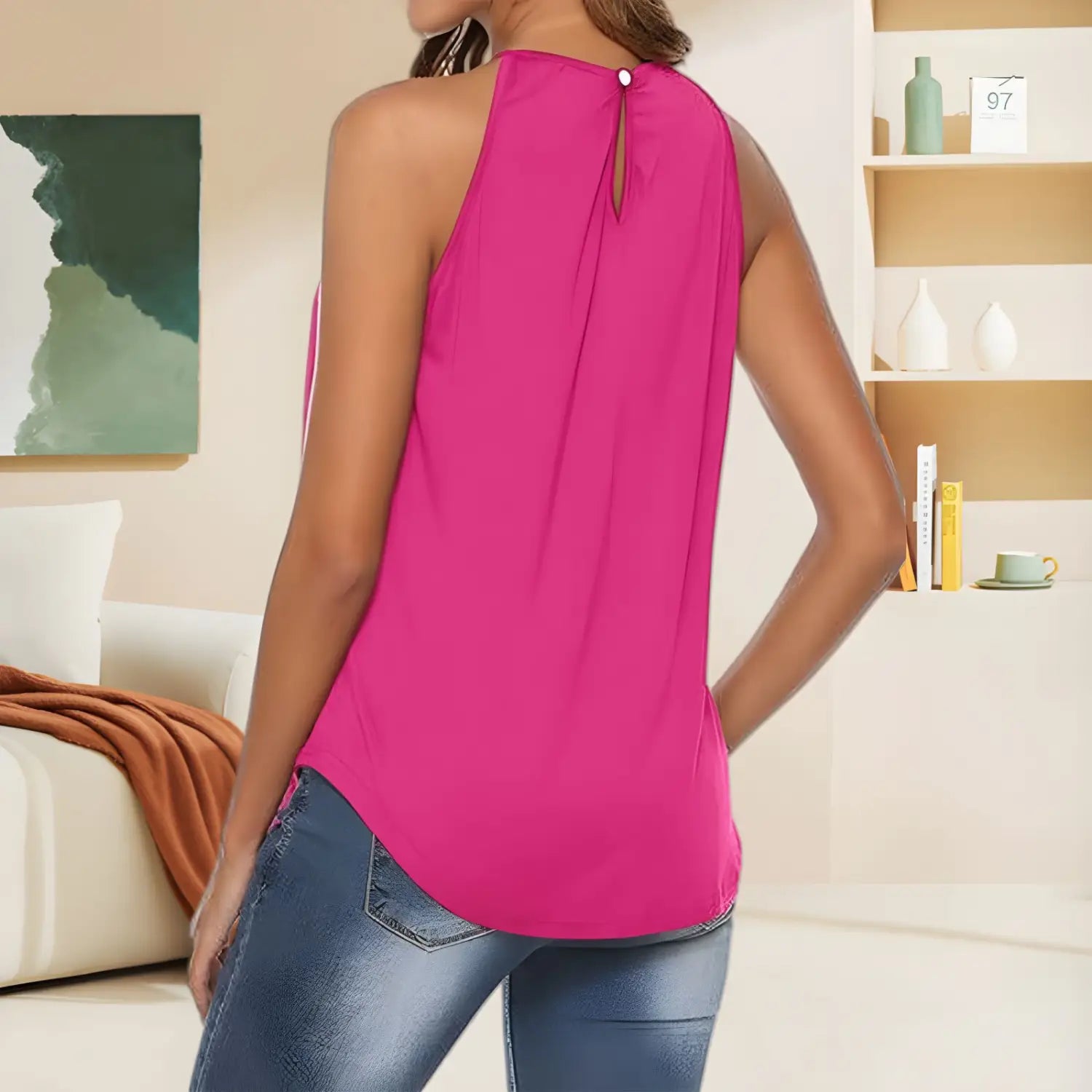 A vibrant fuchsia embroidered halter camisole sleeveless top with a back button closure shown from the back side.