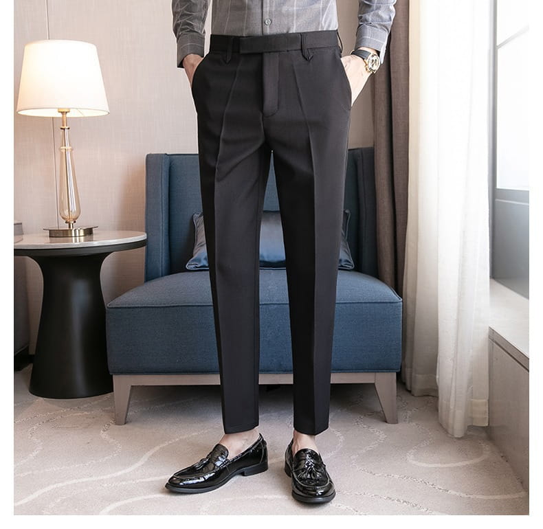 Black slim fit British style tailored straight leg trousers with a sleek modern cut and subtle pleats at the waistband.