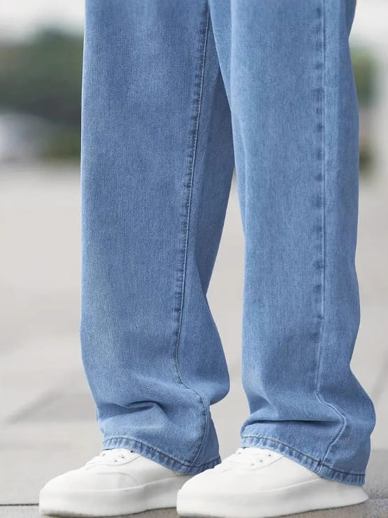 Men’s relaxed straight leg light wash denim jeans featuring a light-wash blue color with a straight-leg cut and visible stitching along the seams.