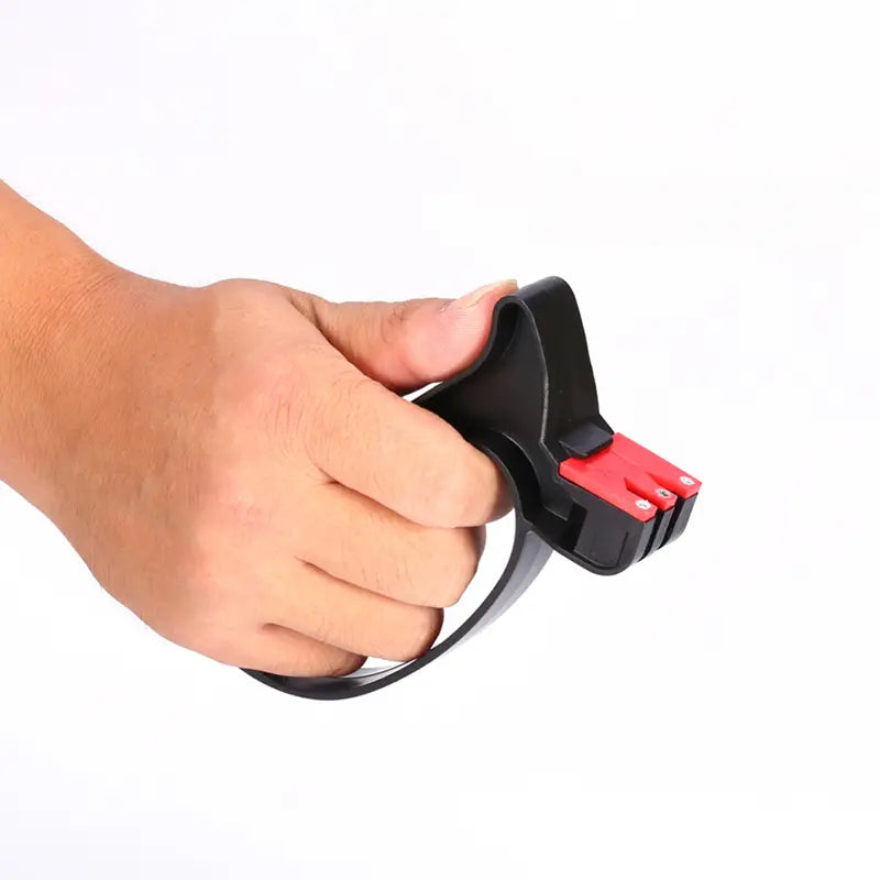 Black and red handheld knife sharpener with a curved handle for easy grip used as a scissor sharpening kitchen tool.