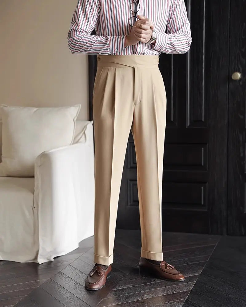 Beige tailored pleated wool straight leg trousers with rolled cuffs designed for men.