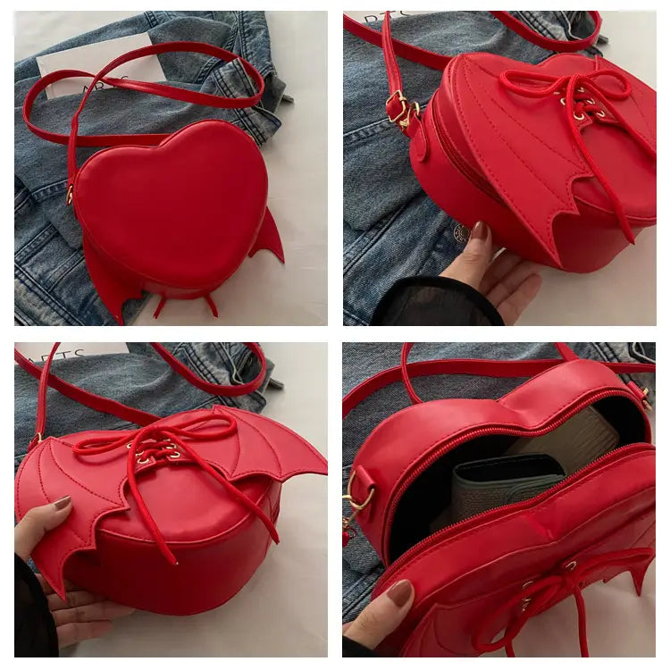 Vibrant red heart-shaped crossbody bag featuring bat-wing details and a lace-up front closure.