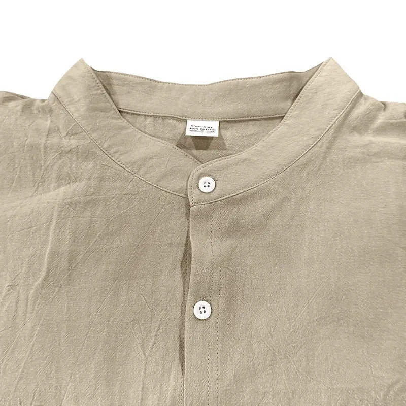 Beige linen men’s casual stand collar long sleeve shirt with subtle texture and white buttons.