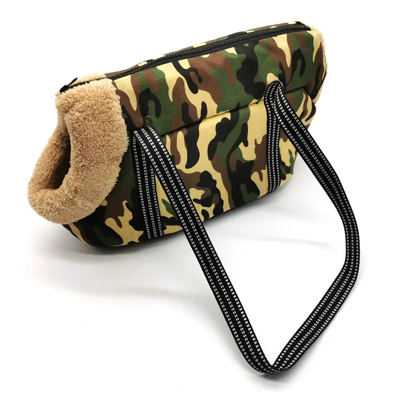 Camouflage-patterned warm pet carrier canvas travel bag with plush tan fleece lining and black reflective-striped straps.