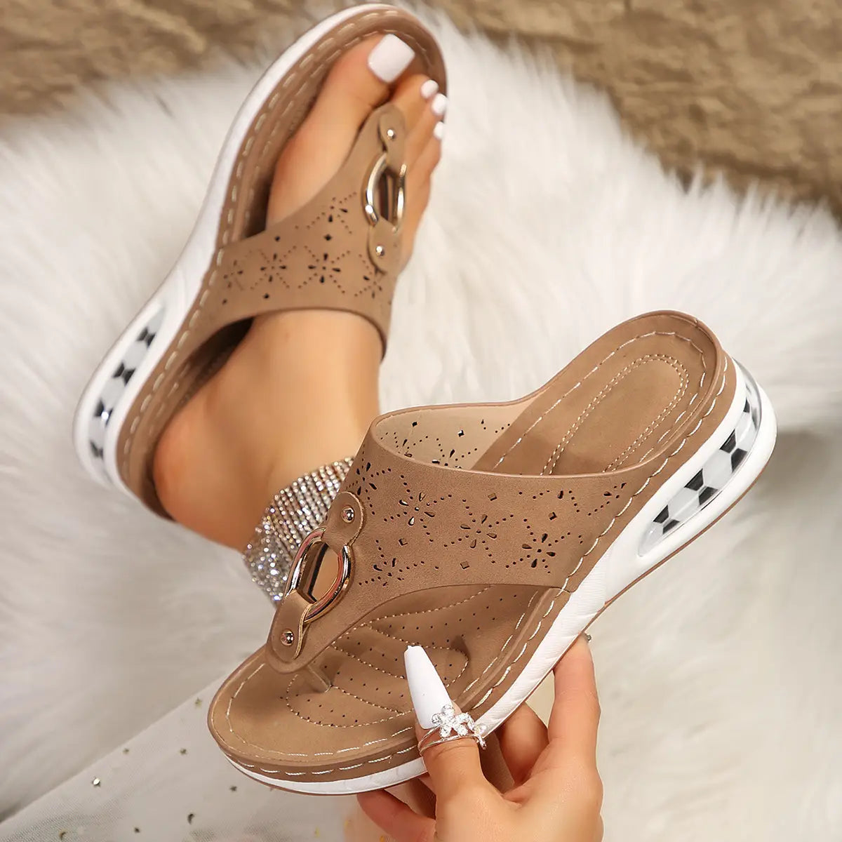 Air cushion thong sandals wedge leather flip flops in tan leather with floral perforations and a white platform sole featuring black diamond-patterned accents.