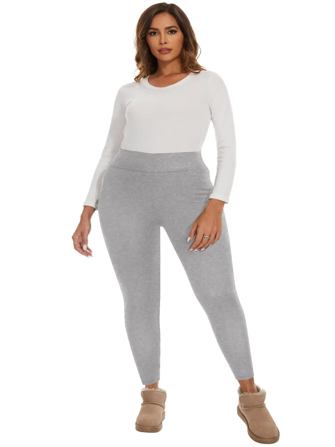 A pair of fleece lined high waisted winter leggings in light gray with a form fitting design, high waistband, and long sleeves.
