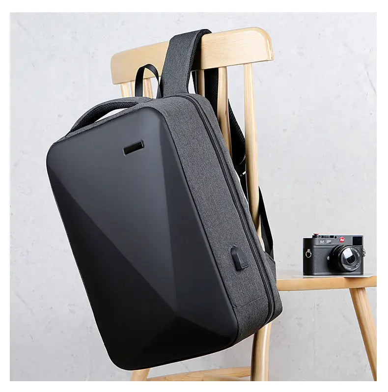 Black business laptop backpack with geometric pattern textured fabric sleek modern design and usb charging port made of oxford cloth.