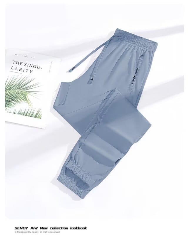 Light blue anti-mosquito casual athletic trousers with elastic cuffs side pockets and a subtle brand logo on the thigh.