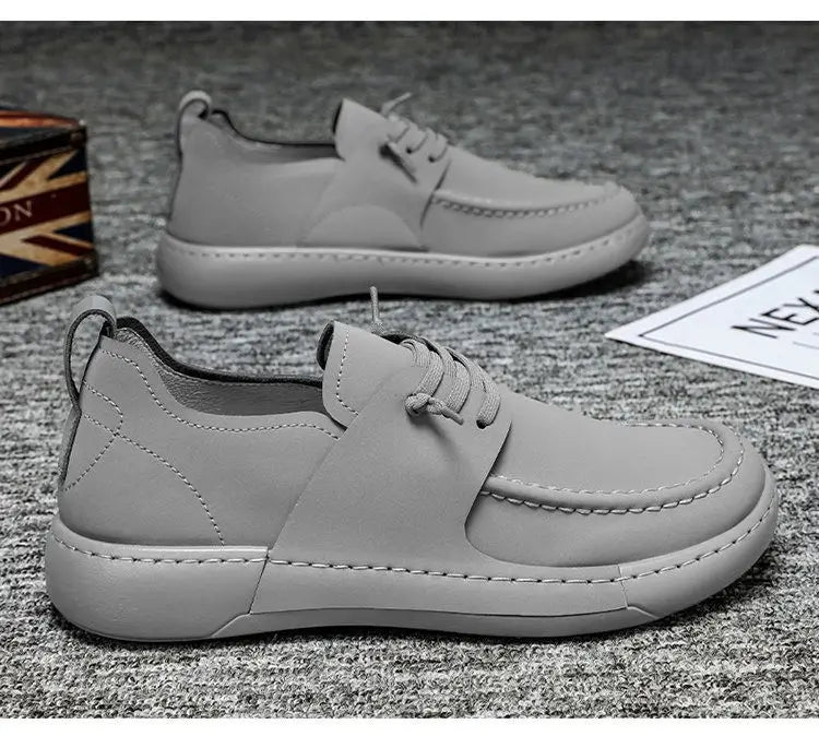 Chaussures en cuir rétro britanniques élégance décontractée pour homme en gris, design enfiler, couture blanche et semelle massive.