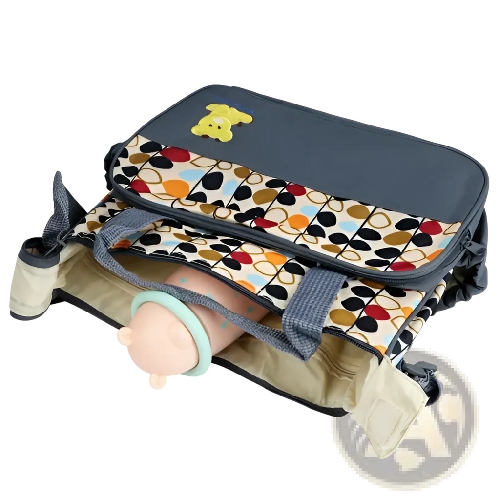 A navy blue and beige geometric pattern diaper bag with a yellow bear emblem, multiple compartments, and sturdy handles
