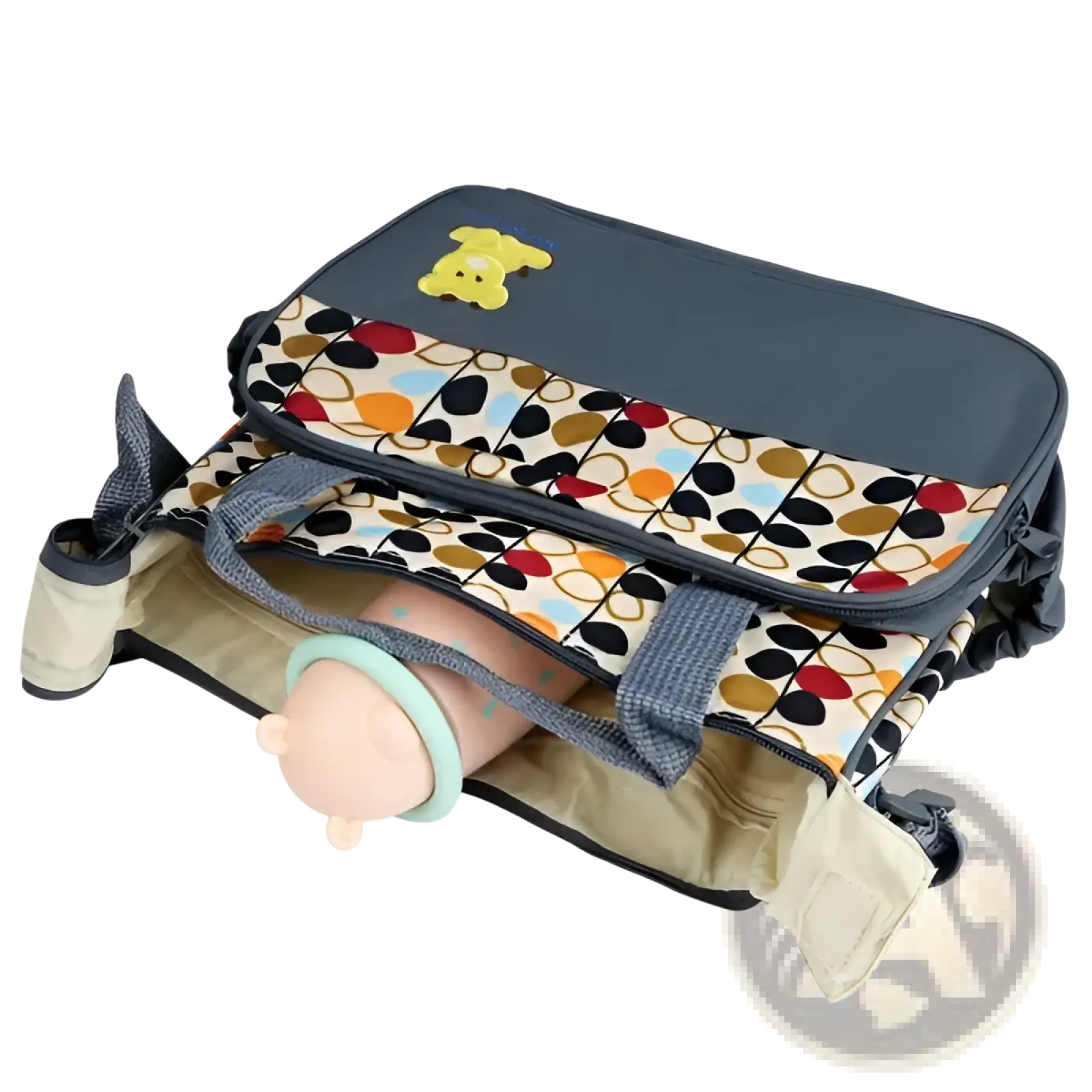 A navy blue and beige geometric pattern diaper bag with a yellow bear emblem, multiple compartments, and sturdy handles