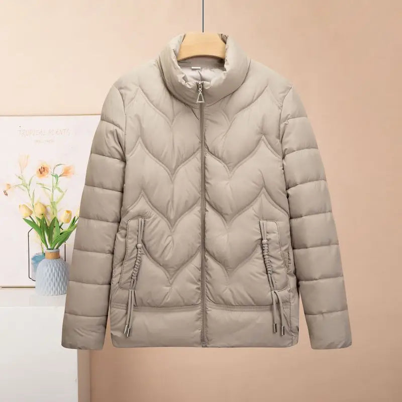 Beige quilted puffer jacket for women winter coat with high collar and heart-shaped stitching pattern.