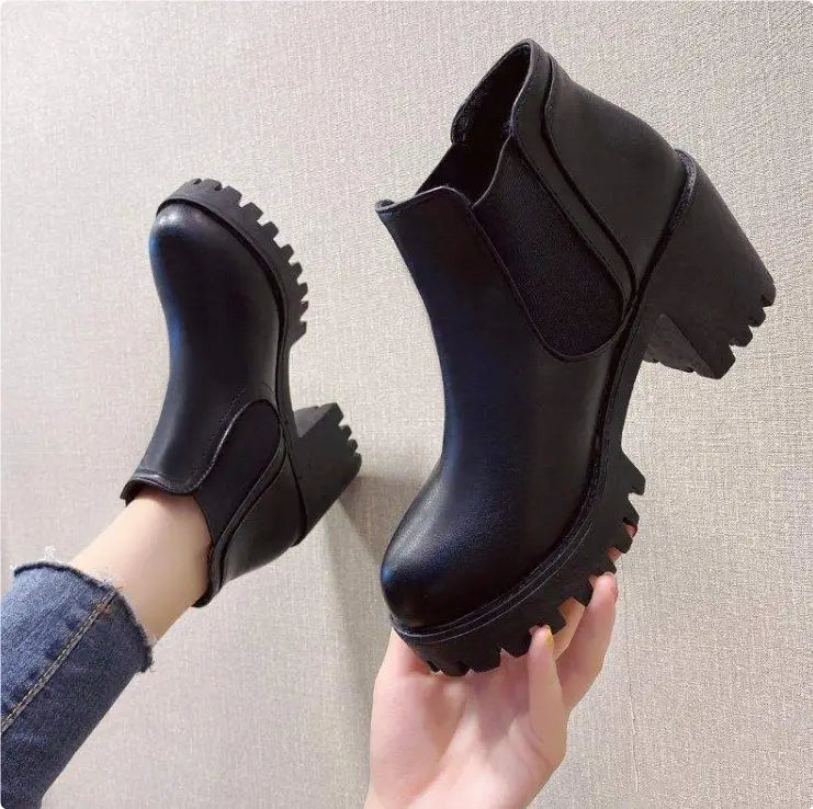 Women’s black leather chunky heel ankle boots featuring a matte finish and rugged textured soles.
