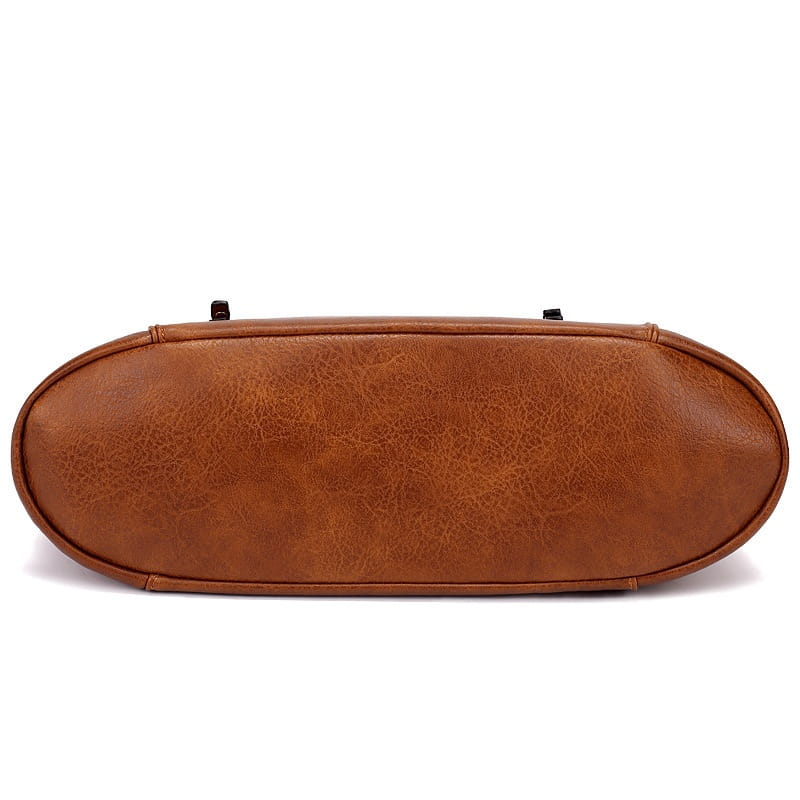 Brown faux leather leather hobo bag with tassel, front zipper pockets, textured slightly cracked surface, and rounded edges.