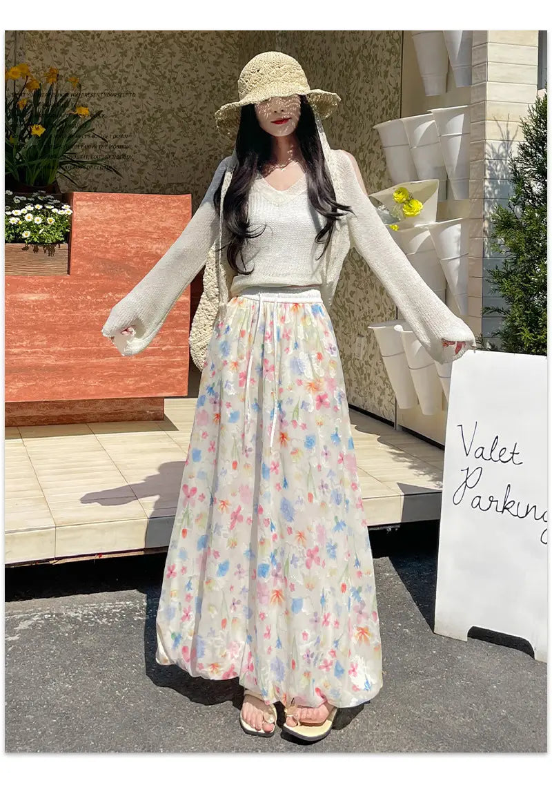 Falda midi con estampado floral, con un diseño maxi floral pastel que fluye, tejido ligero y suave, y delicadas flores multicolores sobre una base color marfil.