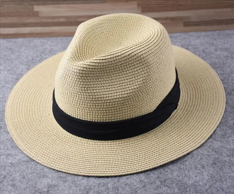 Beige straw fedora hat with black ribbon band foldable for sun protection for men.