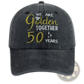 Dark gray denim-style baseball cap with embroidered gold and white text we are golden together 50 years and diamond icon