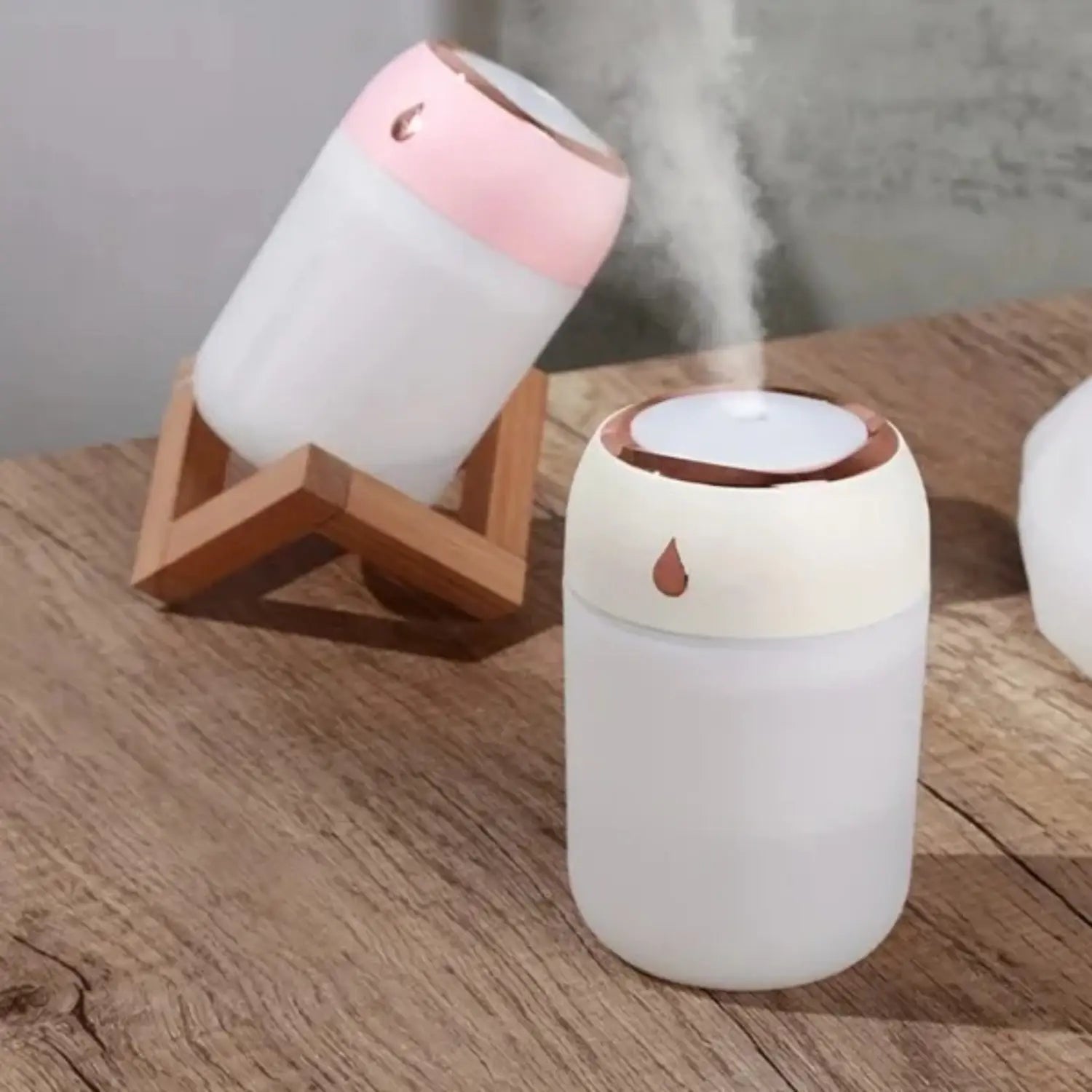 Cute pink and white ceramic ultrasonic USB desktop humidifier with droplet design on the lid and built-in night light.
