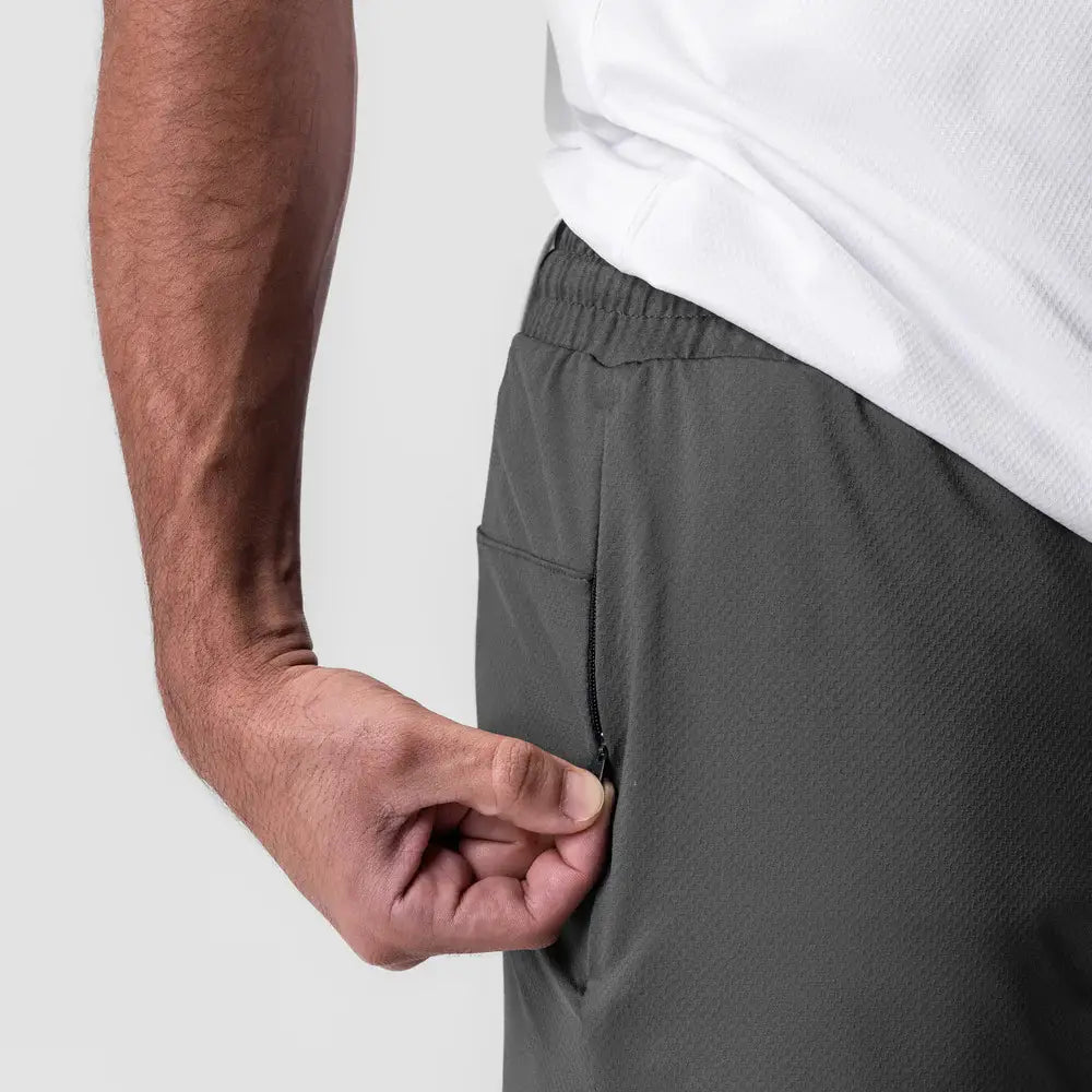Dark gray men quick dry athletic sports shorts with an elastic waistband and a zipper pocket.