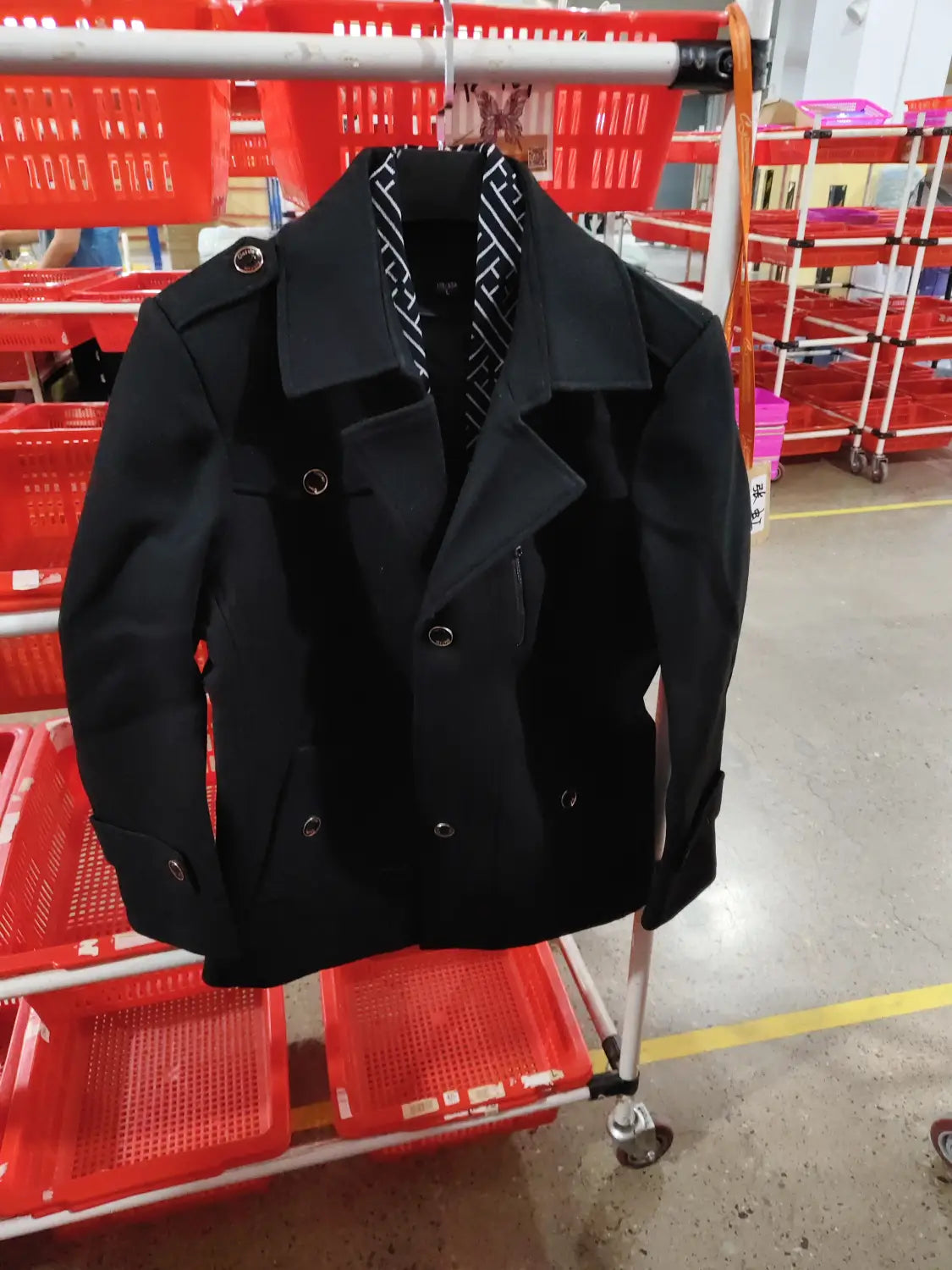 Men woolen trench coat in black featuring silver toned double breasted buttons and a patterned inner lining.