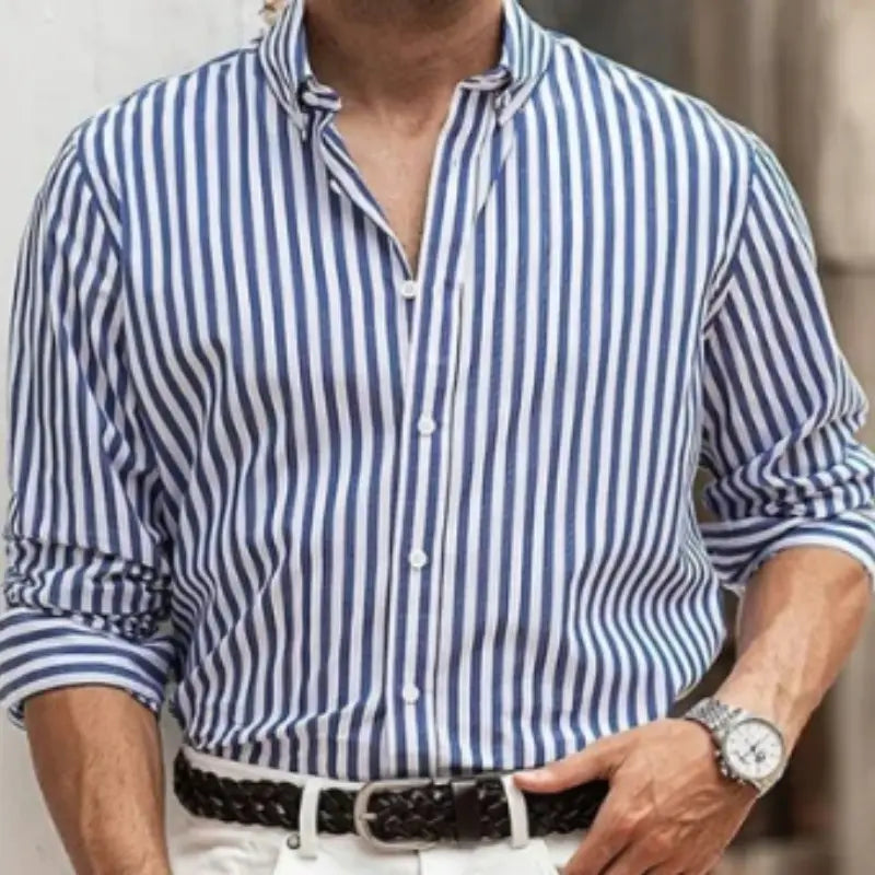 A navy and white vertically striped button down shirt for men with a classic collar long sleeves rolled to the elbow and crisp fabric ideal for casual wear.