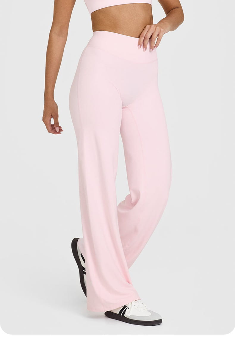 Soft pink slimming yoga pants high waisted straight leg made of smooth stretchy fabric with a wide leg design.
