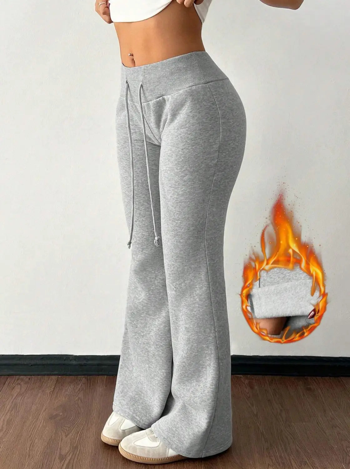 Gray heathered fleece lined high waist sweatpants with a drawstring waistband and flared legs.