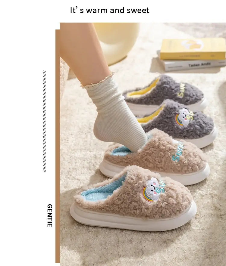Soft beige plush cotton slippers with a light blue lining and a cute rainbow unicorn appliqué on the side from the smiling cloud and rainbow collection.