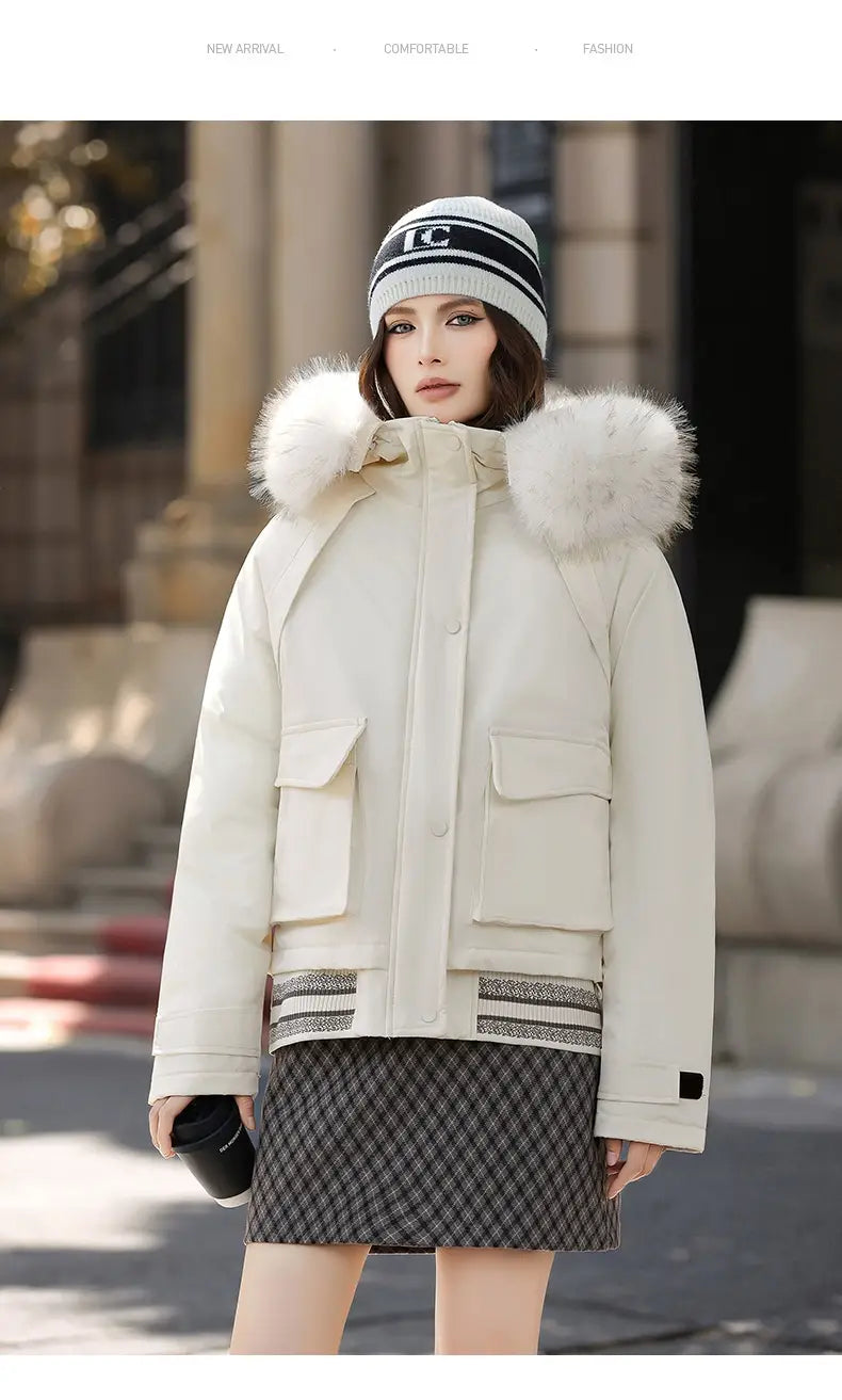 Cream-colored faux fur collar puffer jacket with a fluffy white fur-lined hood, two front patch pockets, and horizontal striped trim at the waist.