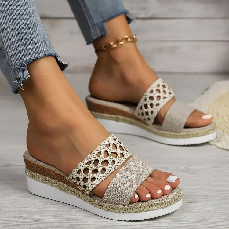 Beige women’s mesh espadrille platform wedge sandals featuring a woven lace-up strap and cork sole.
