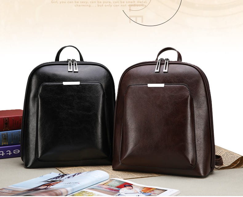 Black and brown pu leather anti theft backpacks with magazine print feature silver zippers and top handles.