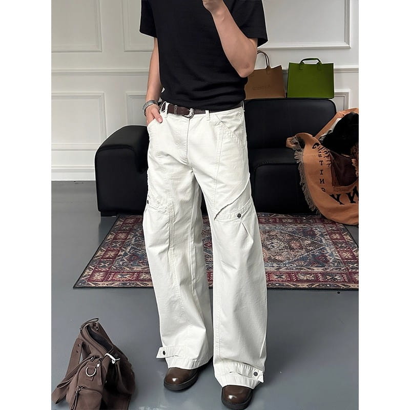 white wide-leg cargo pants featuring multiple pockets and buttoned cuffs in a durable fabric suitable for casual and utility wear