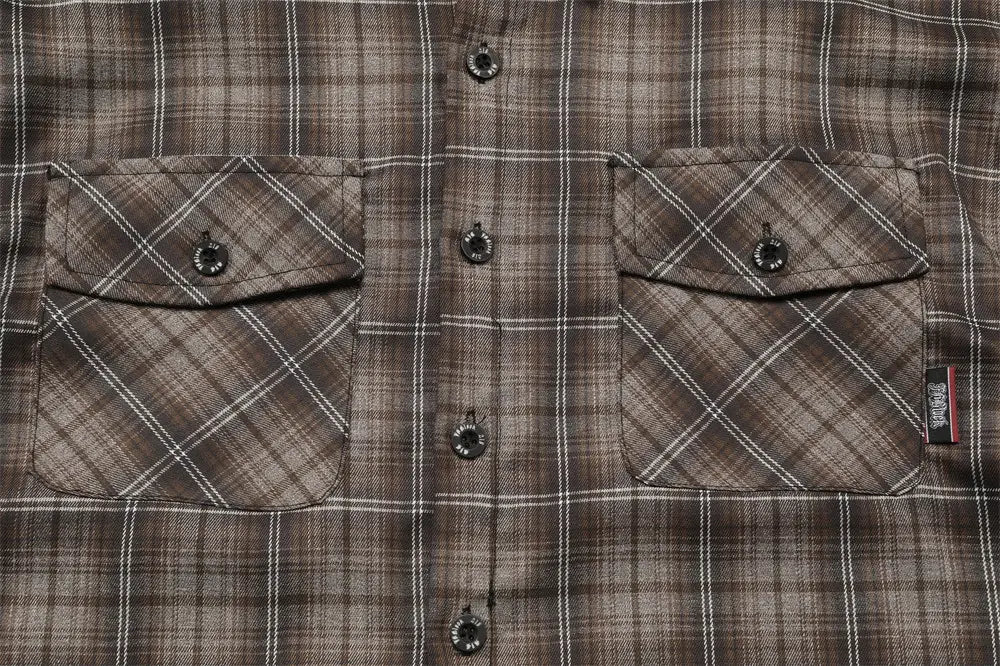 Brown and white plaid flannel embroidered short sleeve shirt with buttoned chest pockets.