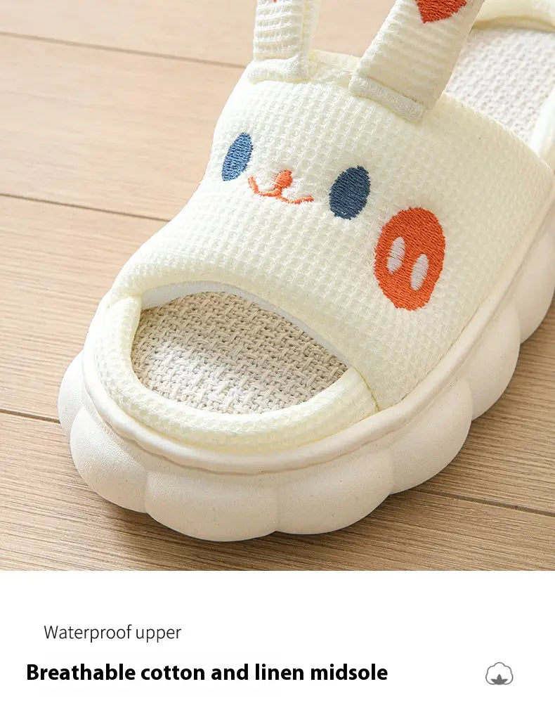 White bunny-themed cartoon animal embroidered open toe linen slippers with blue eyes orange nose and cheeks featuring a textured upper and breathable cotton-linen midsole.