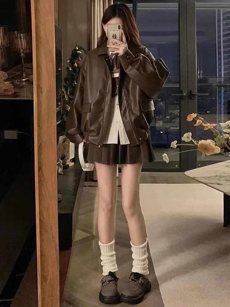 brown faux leather bomber jacket oversized short coat shown from the back side highlighting its relaxed fit and smooth texture