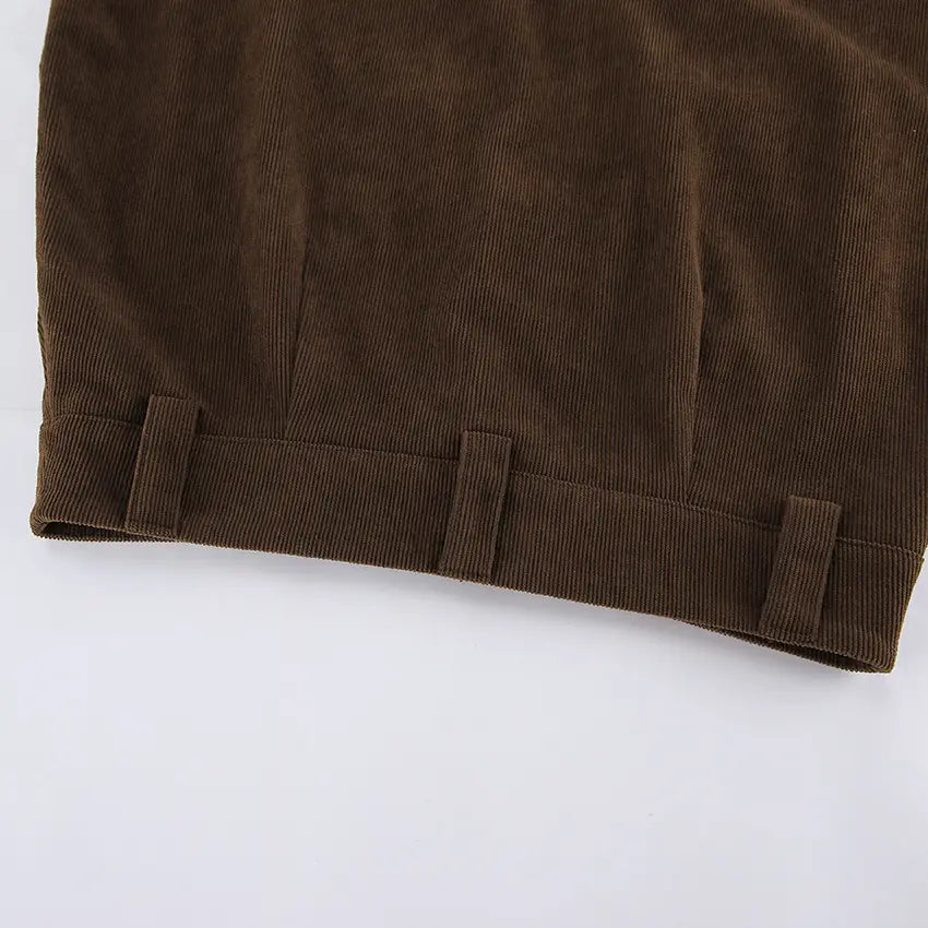 Retro corduroy mini skirt in brown featuring a classic textured weave and neatly stitched belt loops with a matching belt.